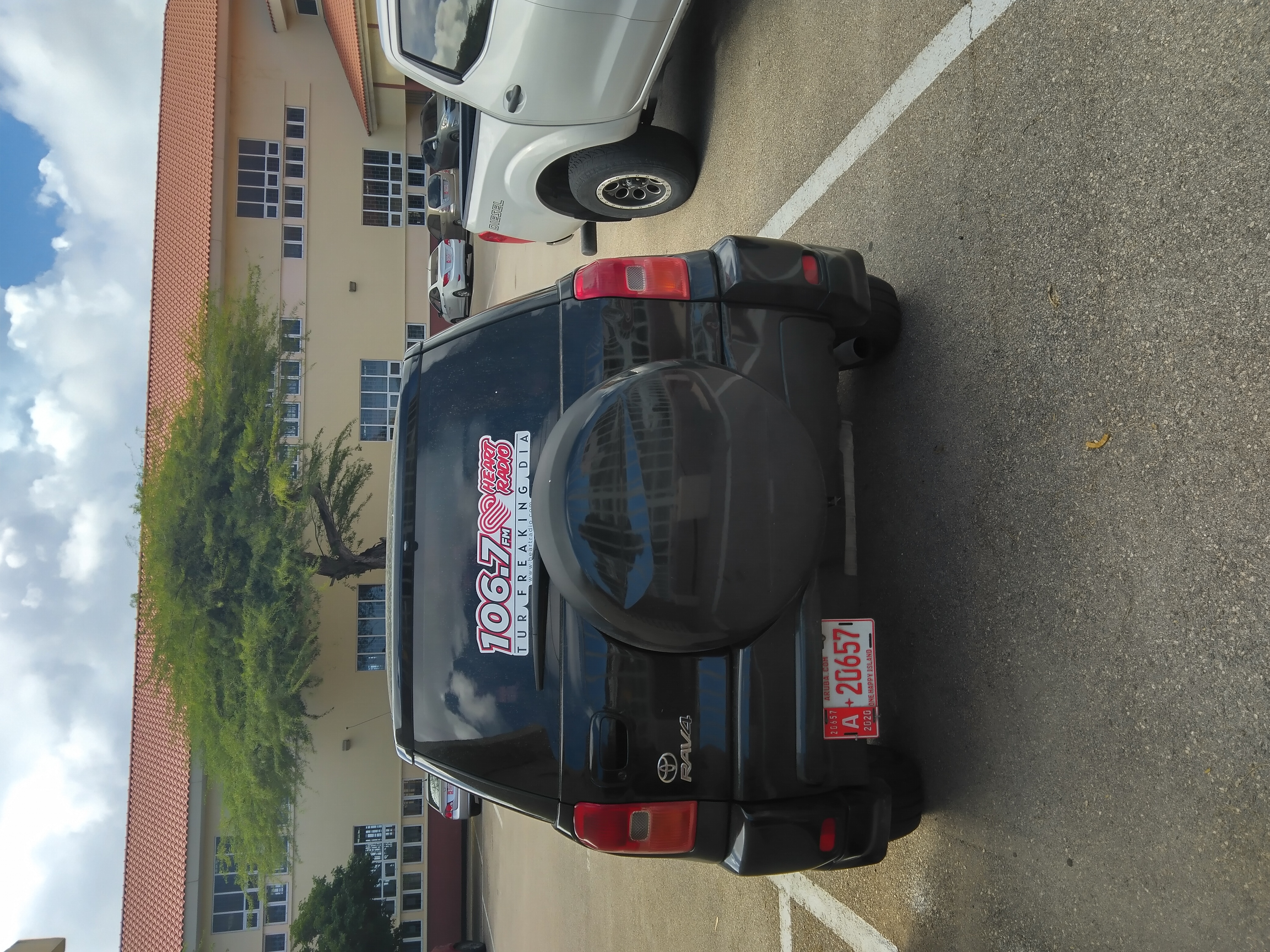 Sticker on a parked car in Oranjestad.